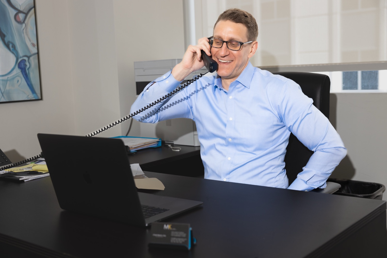 Chad Mason, Esq. taking a client call at MK Law, P.A.