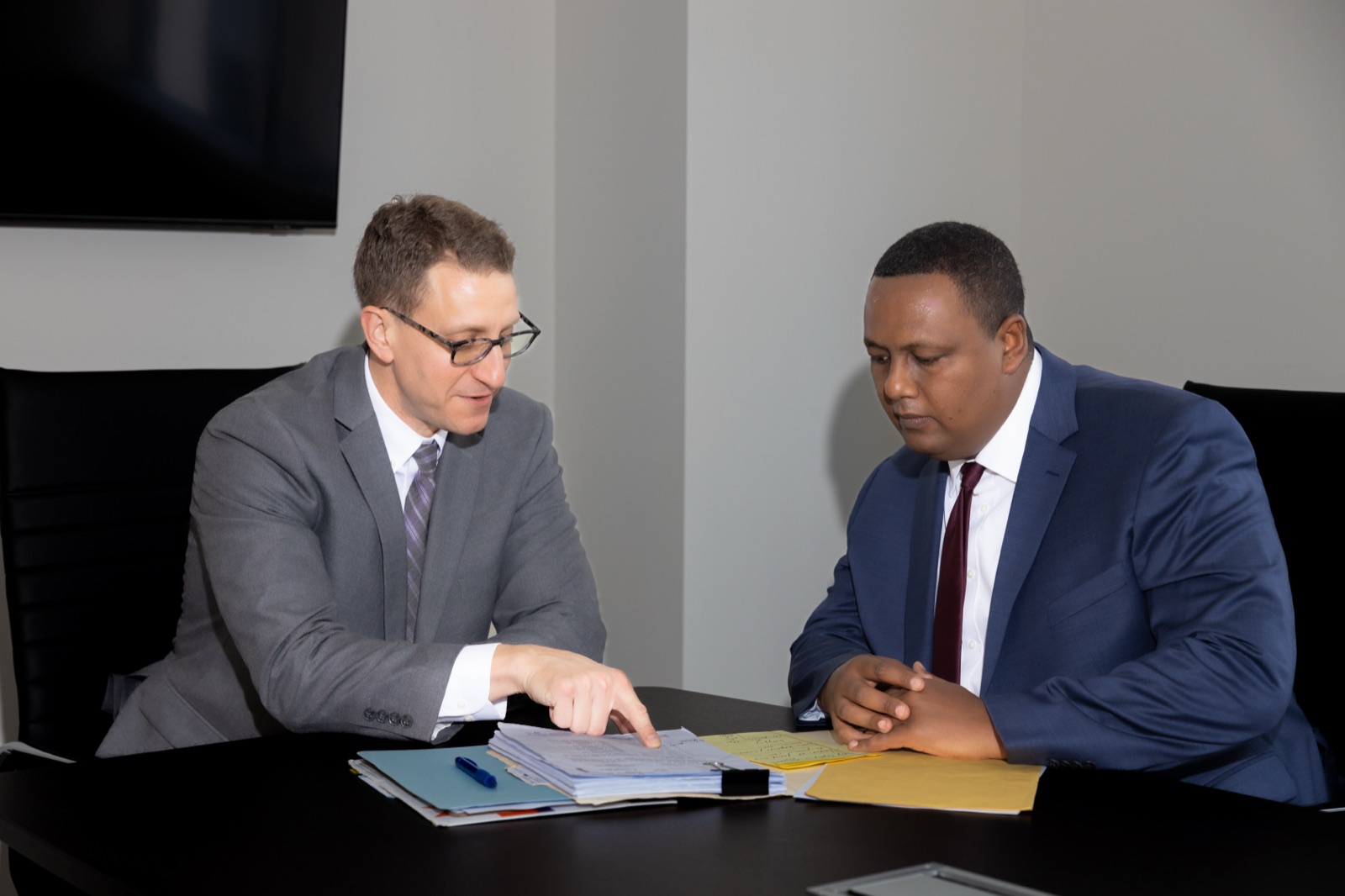 Chad Mason and Kahn Kassegn reviewing a case file together